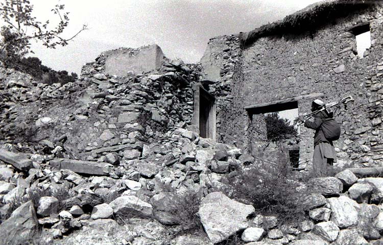 Afghan mujahed Pazlimalek in bombed village, Chowgam valley, Kunar, 1987